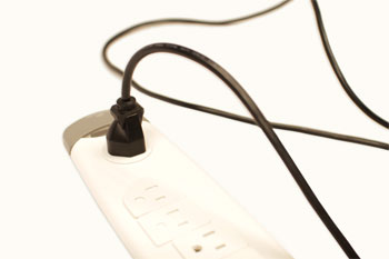 A power cord connected to a surge protector