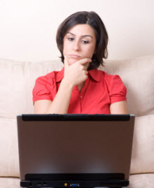 Wary woman at laptop