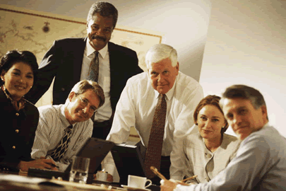 employer and employees standing around table