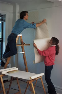 couple installing wallpaper