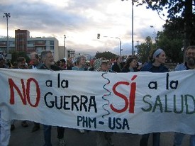 People's Health Movement March in Cuenca, Ecuador. Banner reads "No a la guerra, si a la salud"