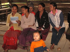 group of people looking at lao materials