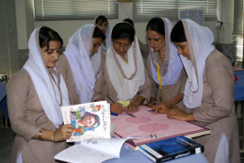 A group of female students make posters together