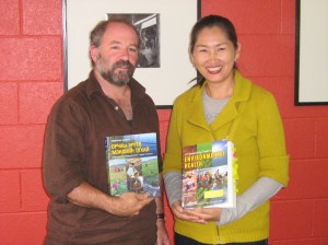 Two translation partners holding books