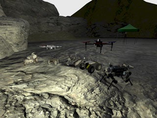 A drone flying over a terrain and a few other vehicles on that terrain as well