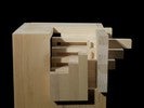 Photograph of bass wood cube model on basewith shifted portions of the cube.