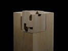 Photograph of bass wood cube model on basewith shifted portions of the cube.