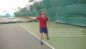 At the end of the stroke, the racket is held outstretched at shoulder level, pointing directly upwards, in the right hand.