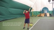 The left hand moves straight up and releases the ball at the top of the motion, and the right hand brings the racket up behind the head, ready to hit the ball.