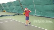 The racket has swung through the rest of the arc, finishing over the left shoulder, with all weight on the left foot.