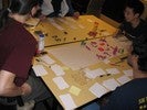 Students around the table have stacks of index cards in front of them.