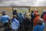 Group examining sign.