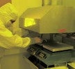 Student leaning over to place wafers onto hot plate.