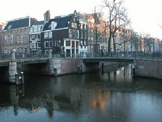 Traditional Dutch buildings with a canal in the foreground.