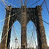 Image of the Brooklyn Bridge taken from on the bridge, looking up.