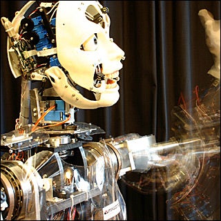 A humanoid robot moving waving its left arm. A humanoid robot moving waving its left arm.