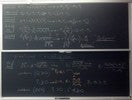 Nuclear reaction related equations on two blackboards.