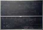 Radioactive decay related equations on two blackboards.