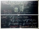 Neutron diffusion related equations and graphs on two blackboards.