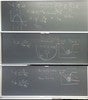 Neutronics related equations and graphs on three blackboards.