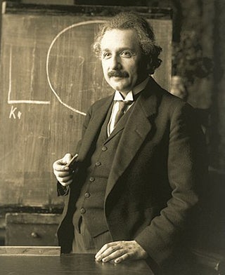 A man standing in front of a blackboard.