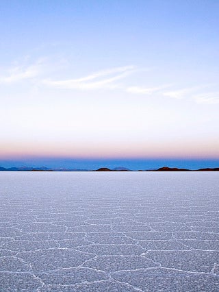 Sun beginning to rise over salt flats.