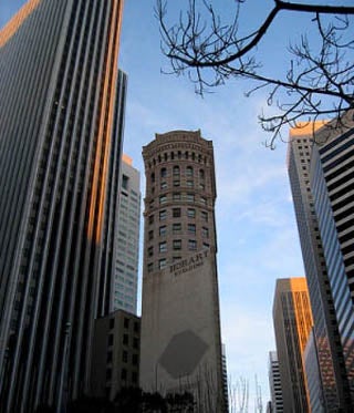 Photograph of tall buildings. Session 19 includes an example of investment in office/resource and development space.