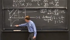 Photo of Professor Gilbert Strang in front of a chalkboard. 