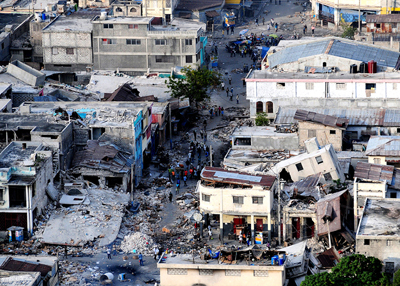 Photo of buildings on a street devastated by an earthquake.