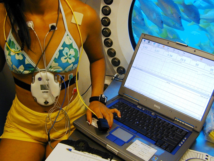 Image of a NASA scientist hooked up to an EKG to monitor their heart rate and vital signs.